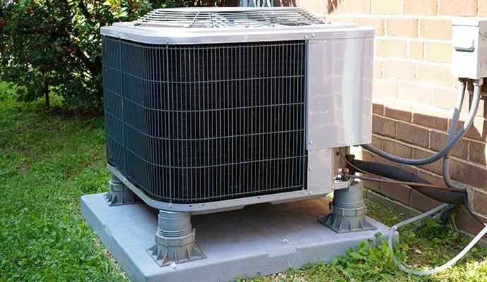 Outdoor central air conditioning unit elevated on risers for diagnostic performance evaluation
