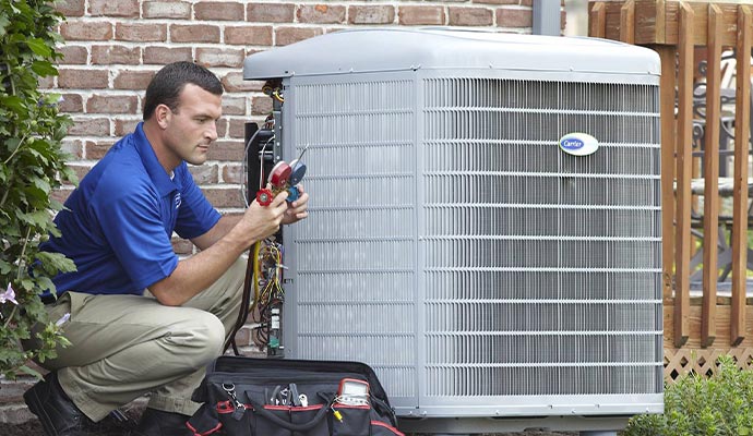 Worker checking air conditioner