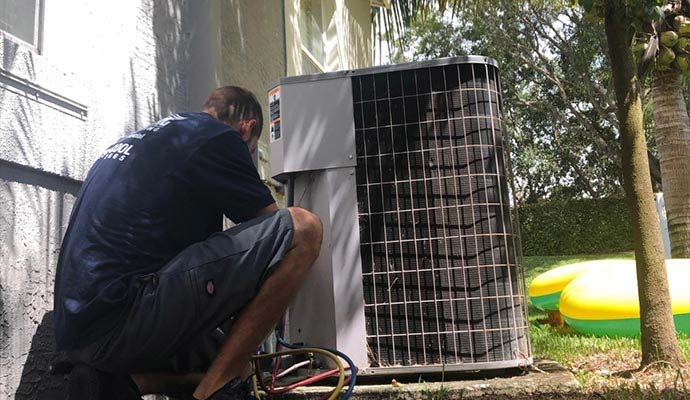 An expert repairing outdoor AC unit