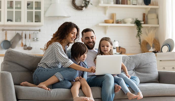 A happy family is sitting on couch and enjoying better air quality