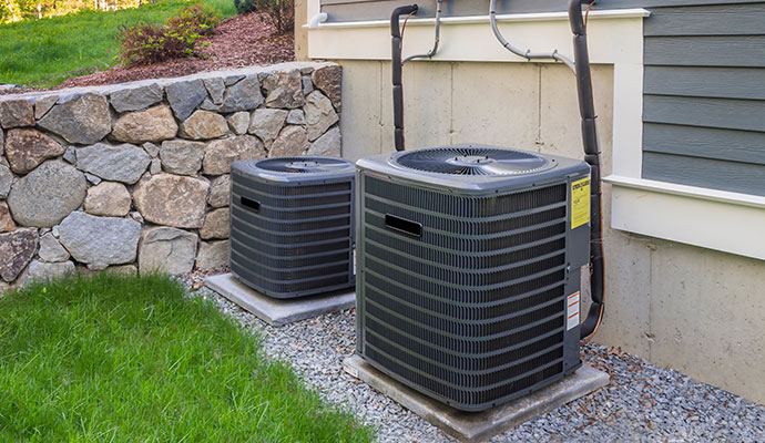 Outdoor central air conditioning condenser units on concrete pads