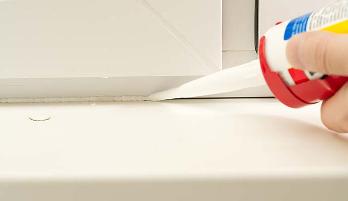 Person using glue to seal leak