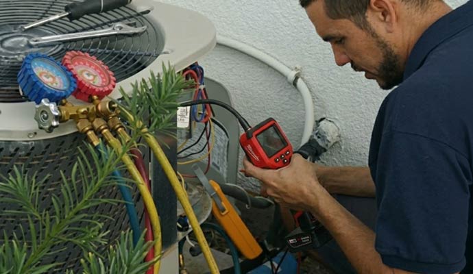 Technician checking an outdoor ac-components