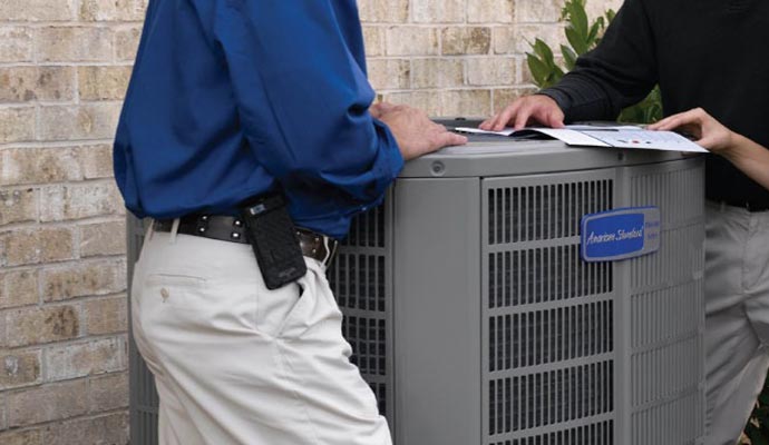 American Standard HVAC unit being inspected by technicians