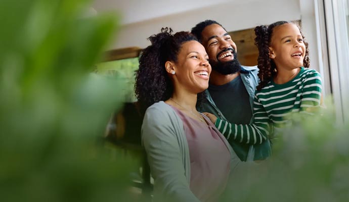 Happy family smiling and looking out together