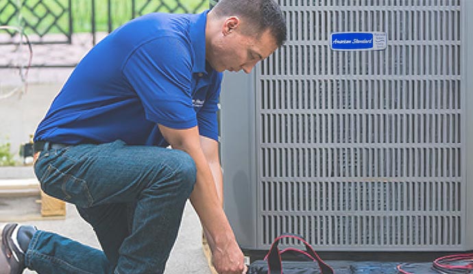 Technician repairing American Standard AC unit