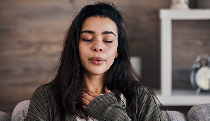 Woman having breathing difficulties due to bad indoor air quality