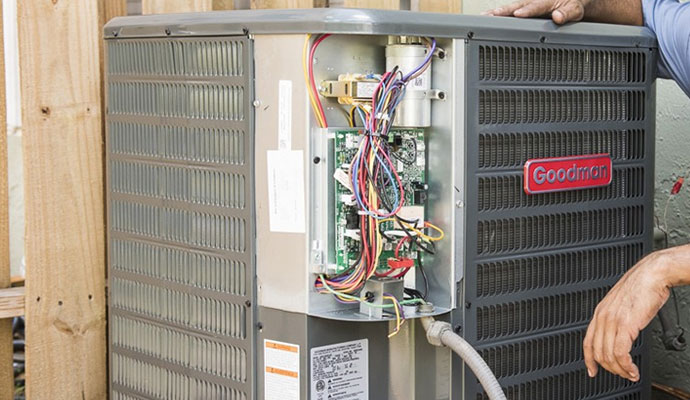 Exposed electrical panel and wiring of a Goodman heat pump during a maintenance or repair service