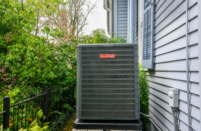 Outdoor perspective of a Goodman product installed outside of a residential property.