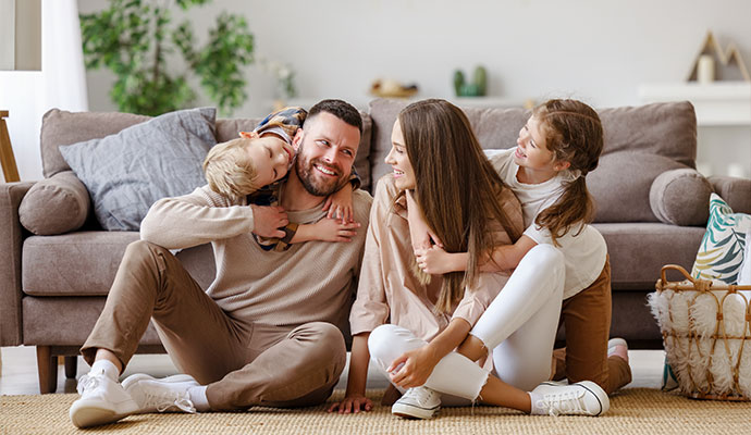 Family sitting comfortably in their living room enjoying healthy indoor air