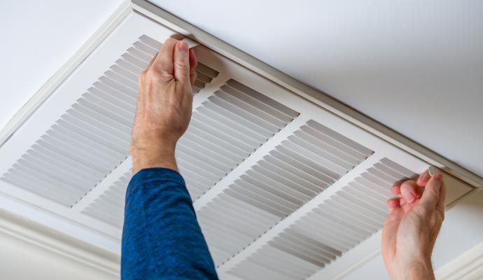 Person installing air filter 