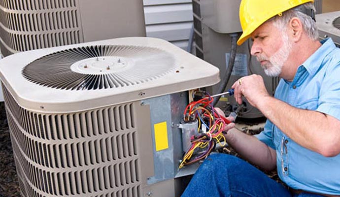 Person repairing AC with equipment