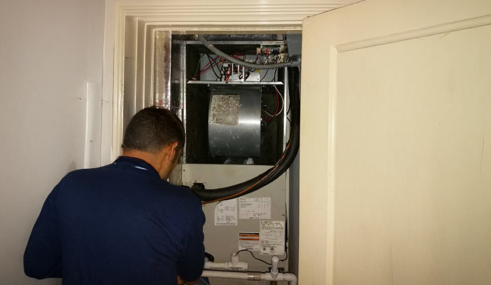 A professional inspecting a heating system
