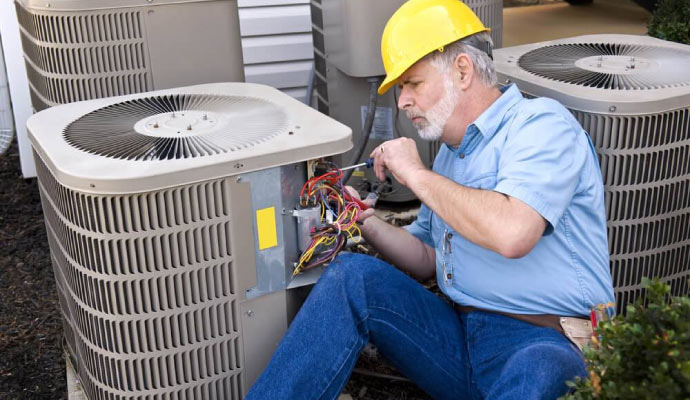 Professional repairing an HVAC system using equipment