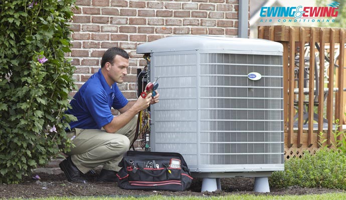 Professional worker servicing heat pump