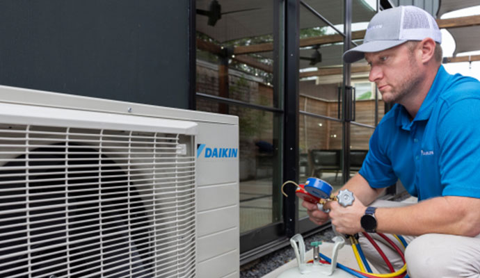 Technician repairing Daikin AC