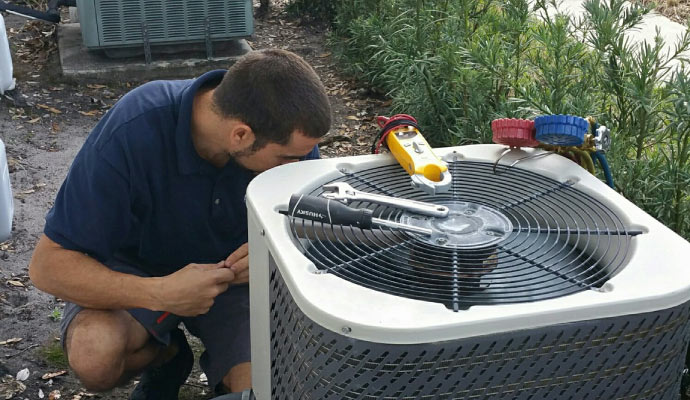 Professional repairing a HVAC system