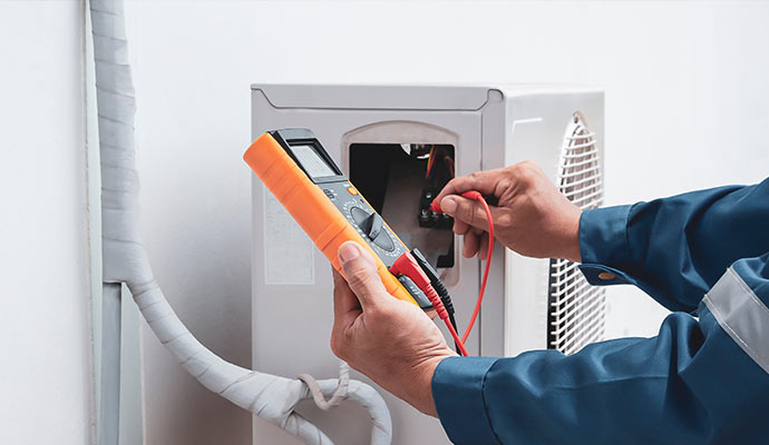 technician repairing air conditioner