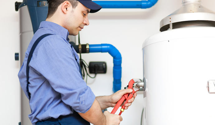 Worker fixing a water heater.