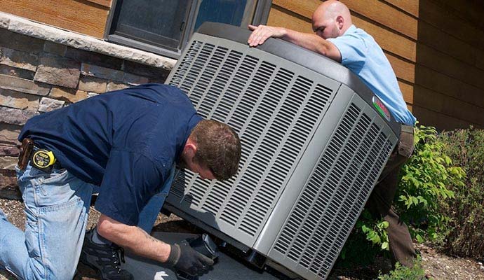 Two experts installing HVAC