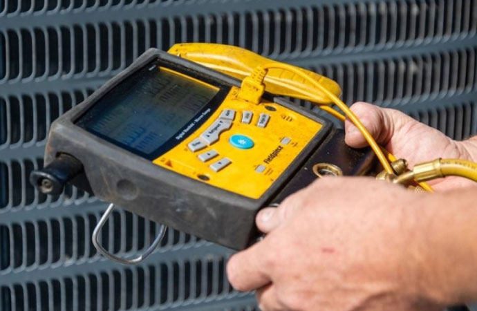 A worker
            inspecting a Goodman product for quality and functionality at a job
            site.